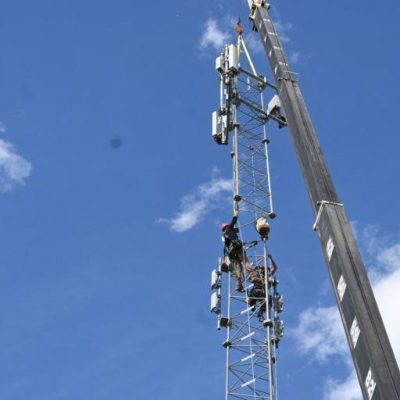 Construction workers working on a communications tower